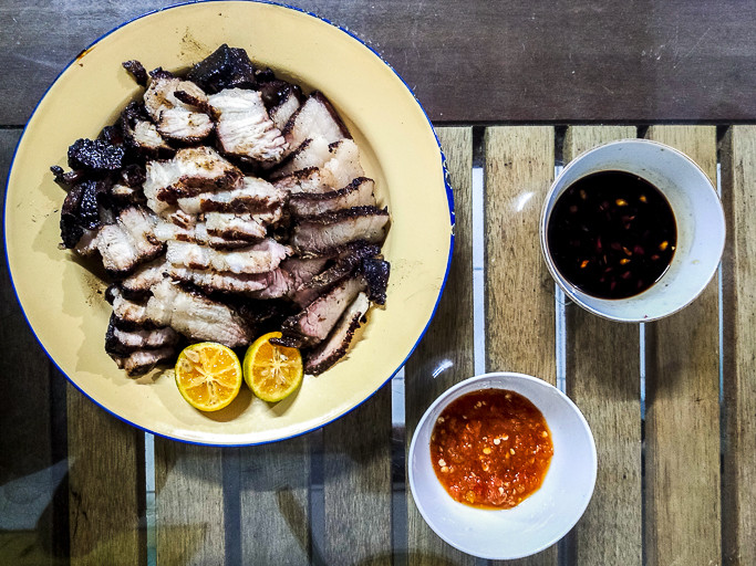 Sliced barbecued pork belly is ready to eat with dipping sauces. Photo: Maynard Keyne Langet