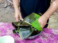 Tying the parcel with the banana rib Tying the parcel with the banana rib