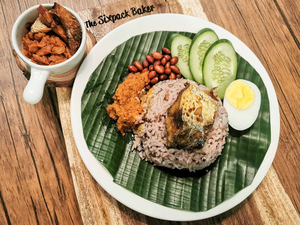 Sabahan style nasi lemak with kinoing or salted fish, sambal takob akob and usual nasi lemak toppings. However, rice cooked in coconut milk is not quite borrowed. Kadazan have traditionally cooked rice in the same manner and called it vinoigan. Photo: The Sixpack Baker